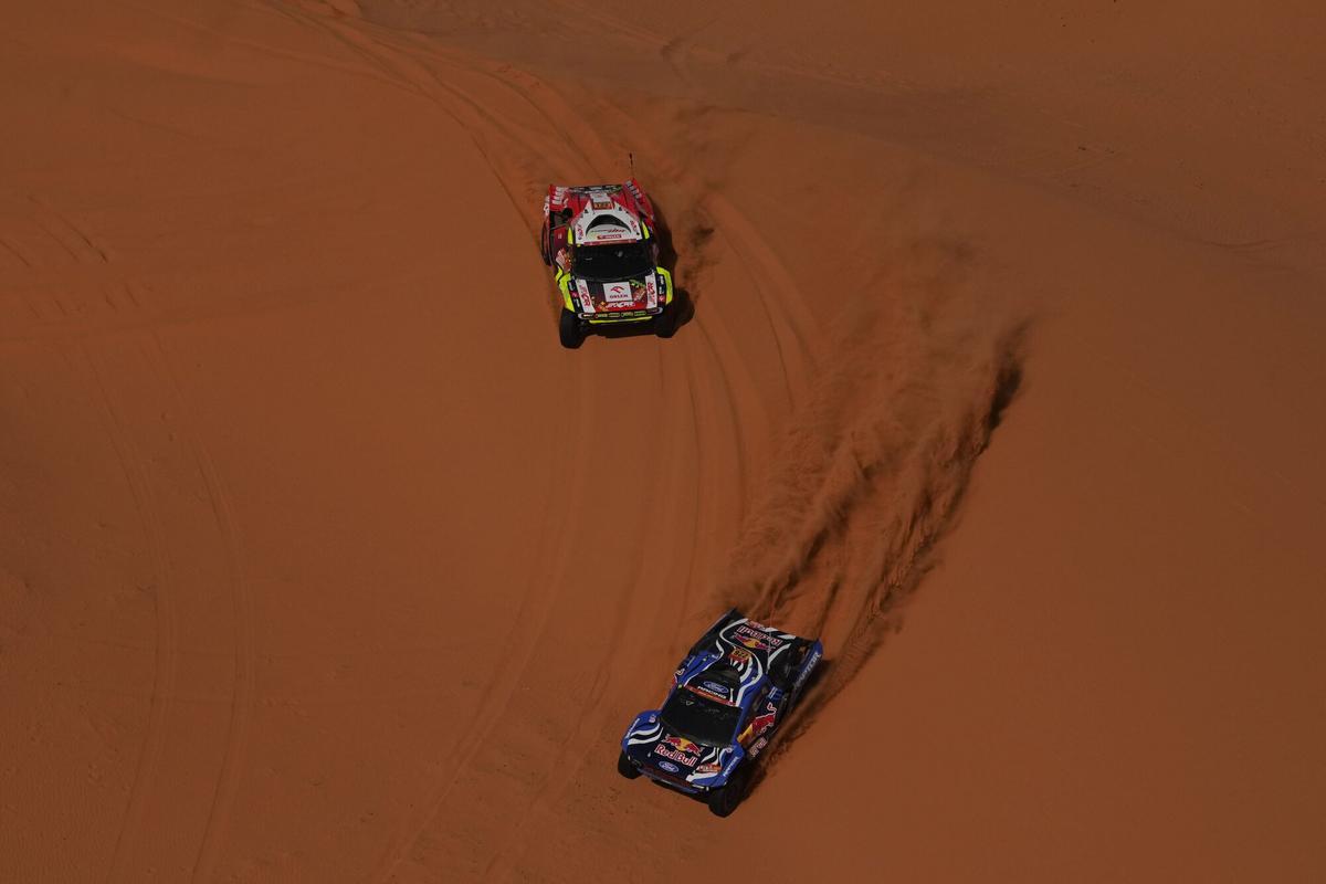 Driver Mattias Ekstrom and co-driver Emil Bergkvist, bottom, and driver Martin Porkop and co-driver Viktor Chytka, top, compete during the sixth stage of the Dakar Rally between Hail and Riyadh, Saudi Arabia, Friday, Jan. 9, 2026. (AP Photo/Thibault Camus)