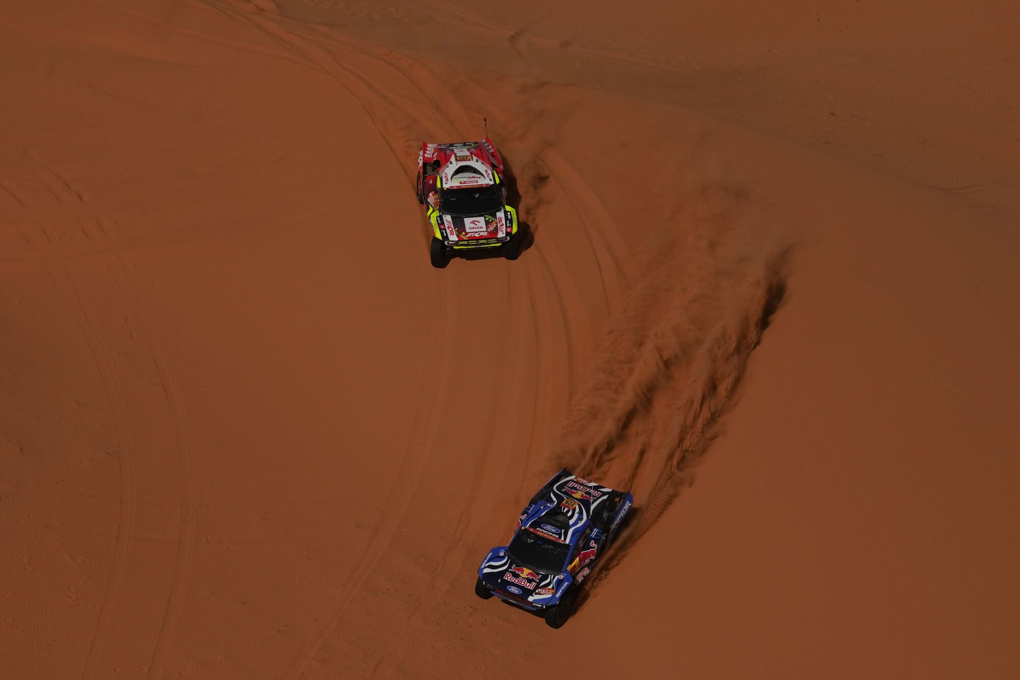 Driver Mattias Ekstrom and co-driver Emil Bergkvist, bottom, and driver Martin Porkop and co-driver Viktor Chytka, top, compete during the sixth stage of the Dakar Rally between Hail and Riyadh, Saudi Arabia, Friday, Jan. 9, 2026. (AP Photo/Thibault Camus)