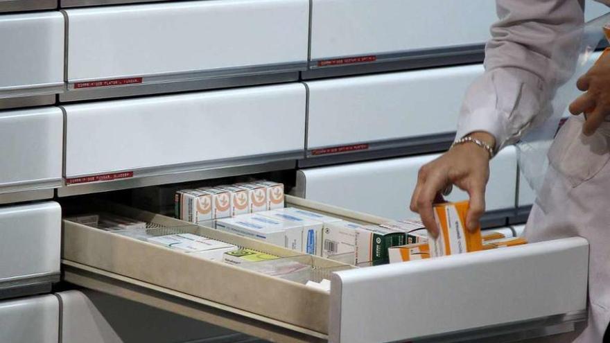 Un sanitario coloca varios medicamentos en un cajón.