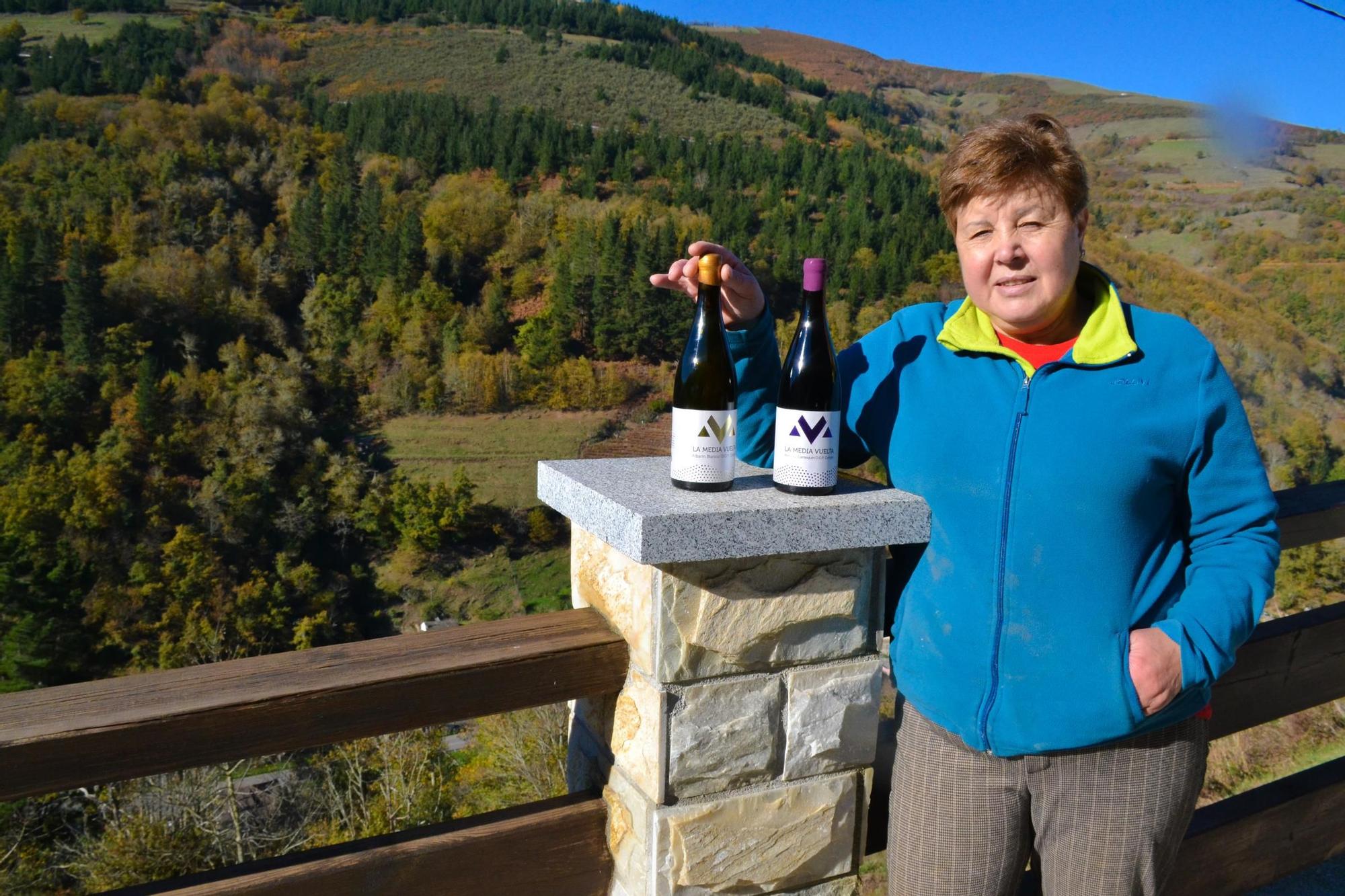 Carmen Martínez con dos botellas del vino que elabora en Cangas del Narcea.