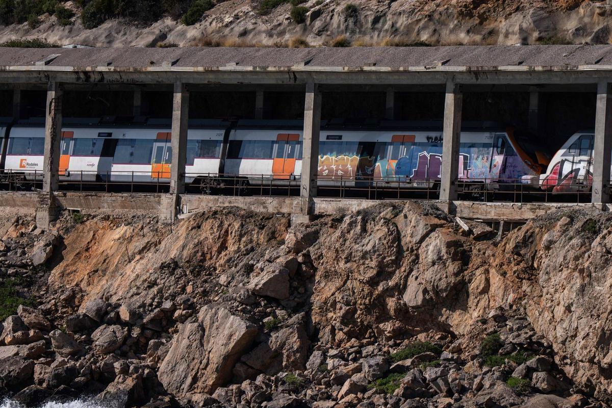 Tunel con vías de tren afectadas y deterioradas donde pasan trenes de Rodalies.