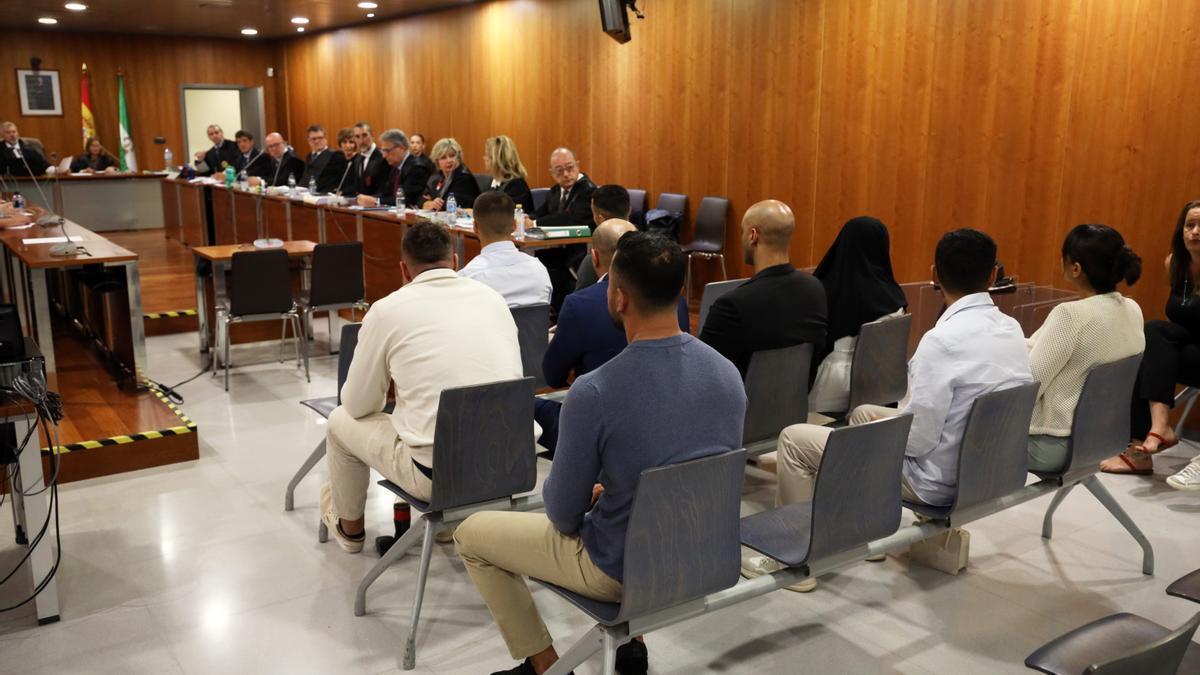 Los acusados, sentados ante el tribunal.