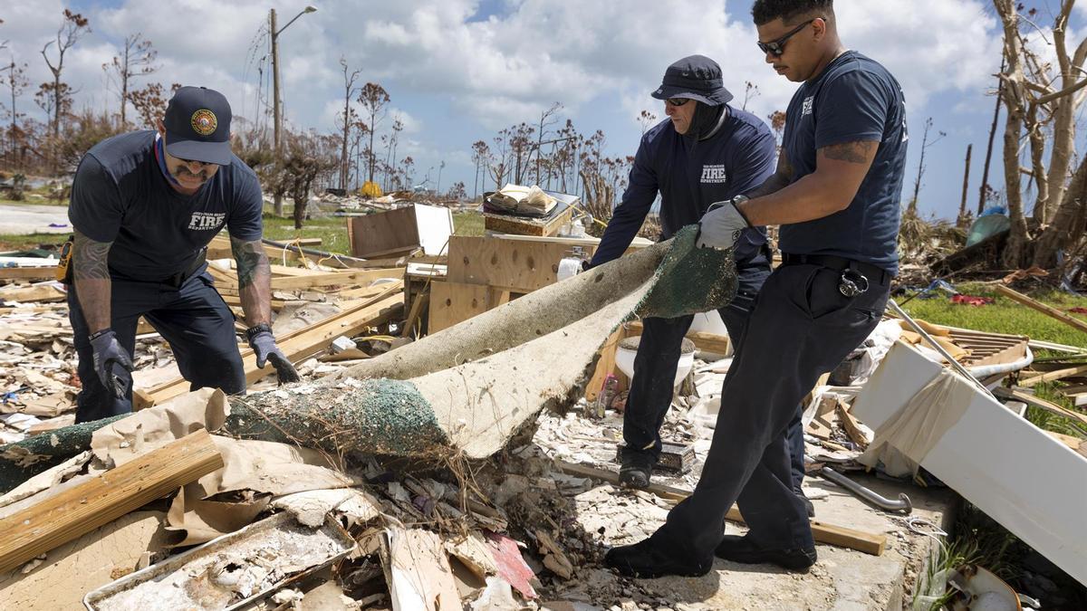 Bomberos de Palm Beach recogen escombros tras los destrozos provocados por el huracán Dorian.