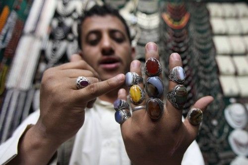 A vendor wears rings with garnet stones at his shop selling garnet and traditional jewellery at the Souq al-Melh marketplace in Sanaa
