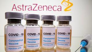 FILE PHOTO: Vials with a sticker reading, COVID-19 / Coronavirus vaccine / Injection only and a medical syringe are seen in front of a displayed AstraZeneca logo in this illustration taken October 31, 2020. REUTERS/Dado Ruvic/Illustration/File Photo