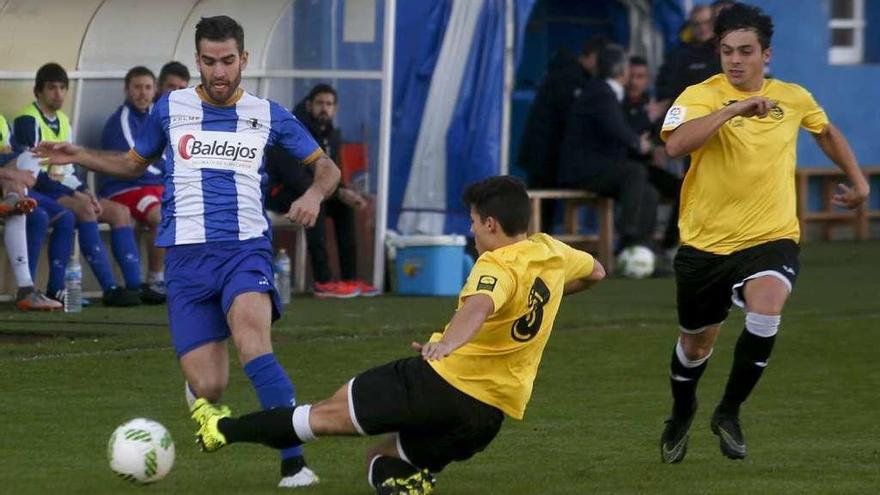 Marcos Torres trata de llevarse el balón ante la entrada de un jugador del Urraca.