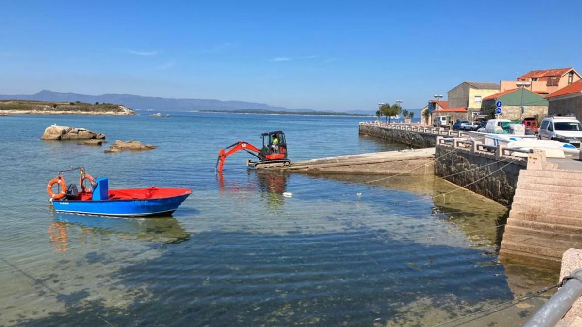 Una máquina realiza las obras de mejora en la rampa. A la derecha, el paseo de Terra de Porto-Lordelo.