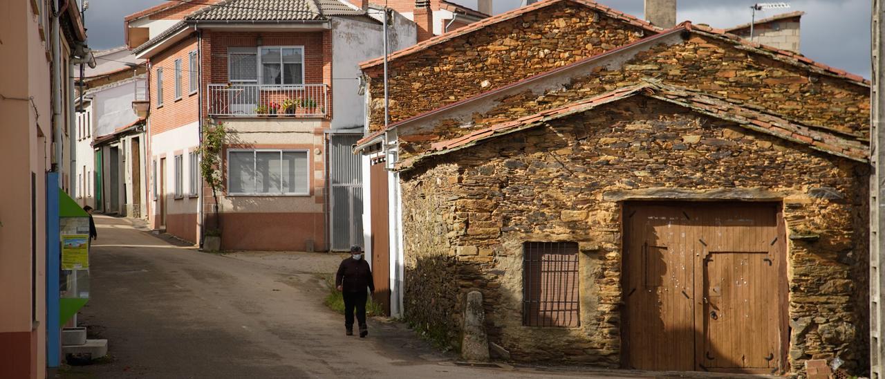 Un vecino pasea por las solitarias calles de su pueblo