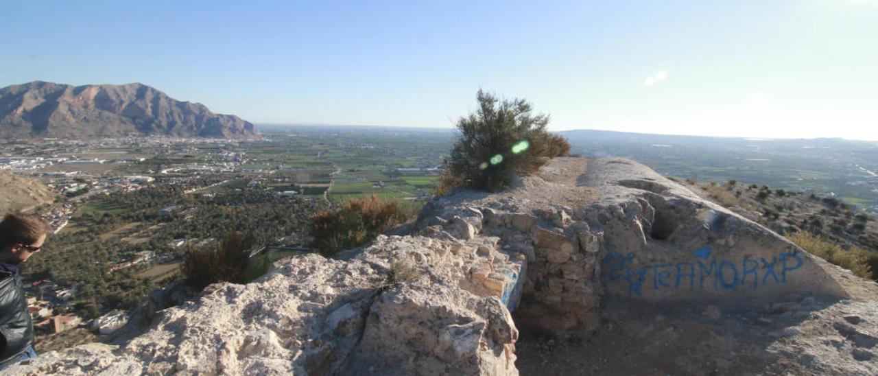 Grafitis sobre uno de los muros que quedan en pie del Castillo de Orihuela, en lo alto del Monte de San Miguel.