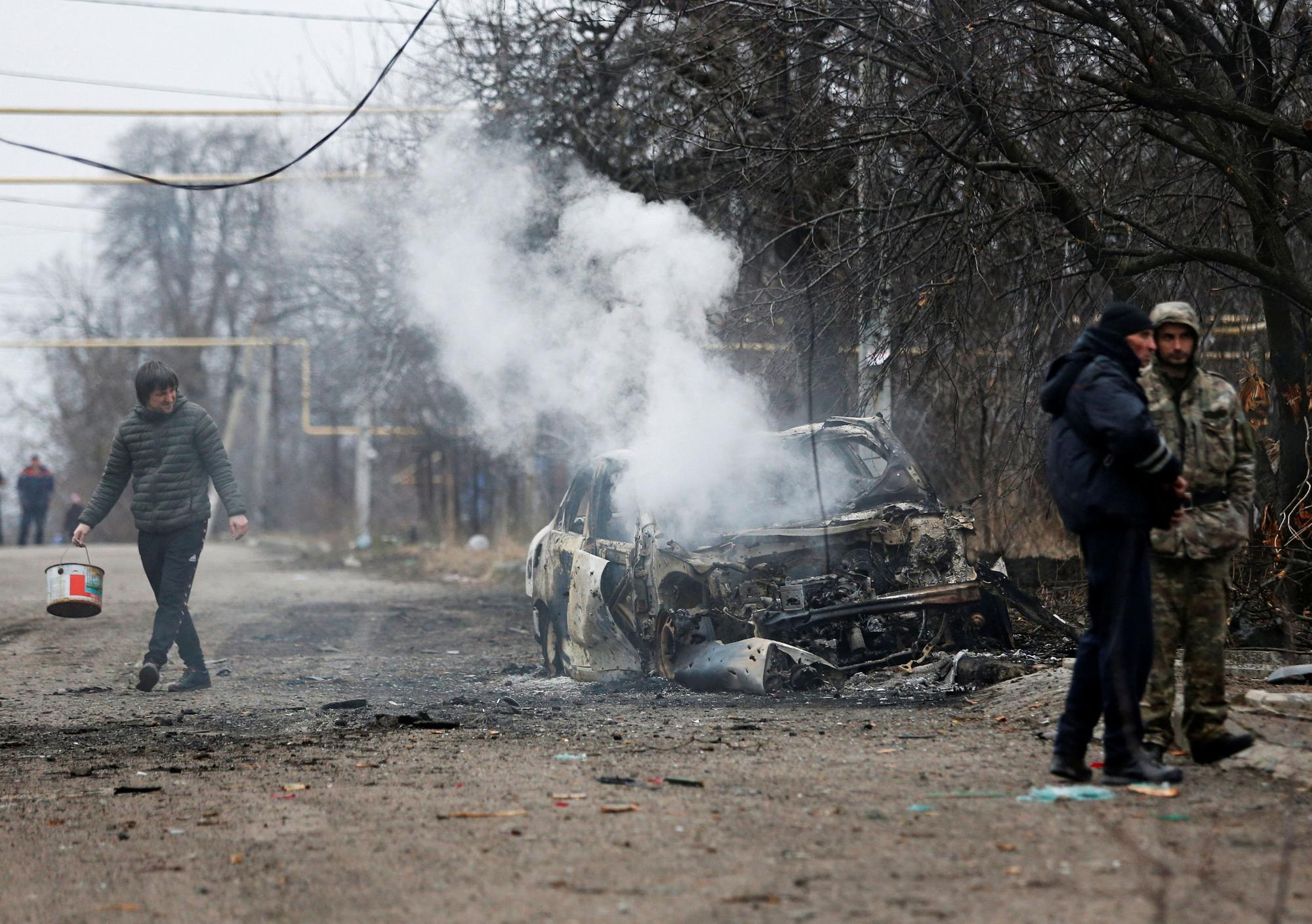 El humo sale de un automóvil quemado después del bombardeo del 28 de febrero de 2022 en la ciudad de Donetsk, Ucrania.