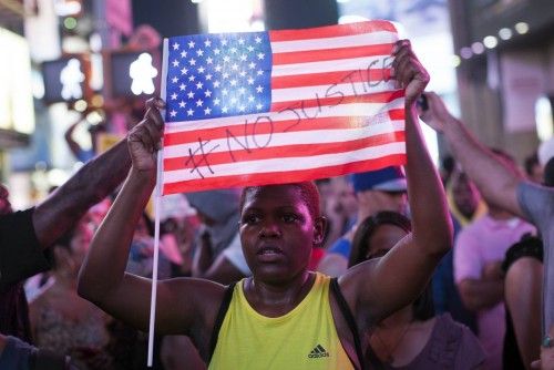 Protesters rally in response to the acquittal of George Zimmerman in the Trayvon Martin trial in Times Square in New York