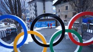 People walk past Olympic rings at the 2026 Winter Olympics, in Bormio, Italy, Wednesday, Feb. 4, 2026. (AP Photo/Rebecca Blackwell)