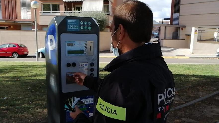 Un dels Mossos analitzant un dels parquímetres de Lleida