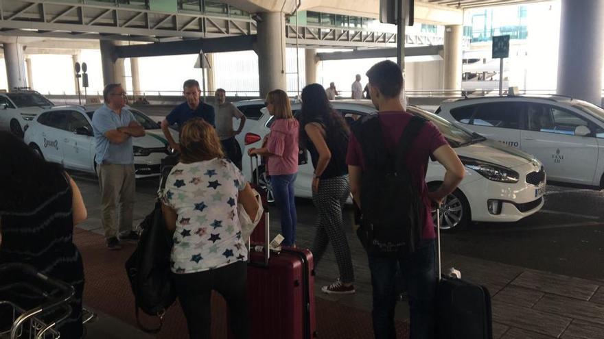 Pasajeros, buscando un taxi esta mañana en el aeropuerto