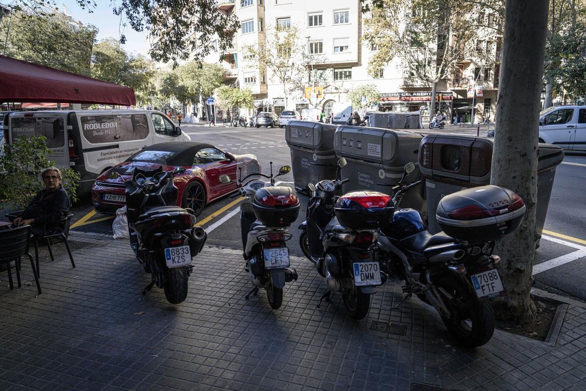 Motos mal aparcadas impidiendo el acceso a los contenedores de basura en el Eixample.