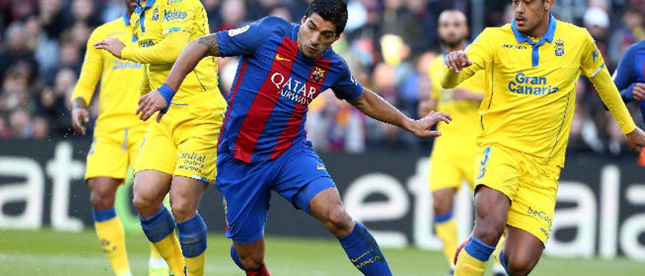 Luis Suárez intenta hacerse con el balón ante la oposición de Roque Mesa y Mauricio Lemos.