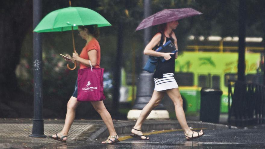 Dos mujeres se protegen de la lluvia en Valencia.