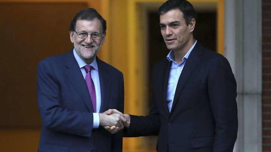 Rajoy y Sánchez se saludan en la puerta del palacio de la Moncloa antes de la entrevista. // Efe
