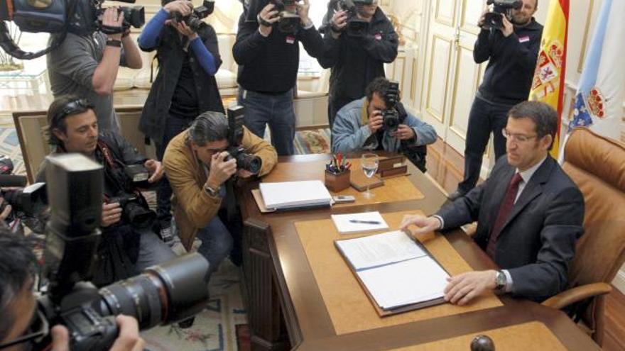 El presidente de la Xunta de Galicia, Alberto Núñez Feijóo (d), durante la presentación de la estructura orgánica de su gobierno y los nombres de los titulares de cada consellería que ha tenido lugar esta mañana en el Palacio de Raxoi, en Santiago de Compostela. EFE/Lavandeira jr