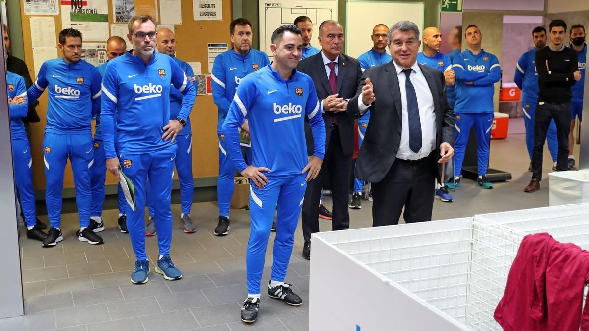 Xavi y Laporta, en primer término, con el nuevo cuerpo técnico detrás, en su presentación a la plantilla.