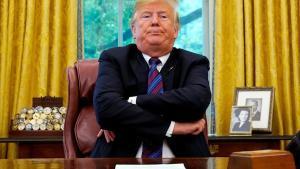 undefined44801044 u s  president donald trump sits behind his desk as he annou180829120953