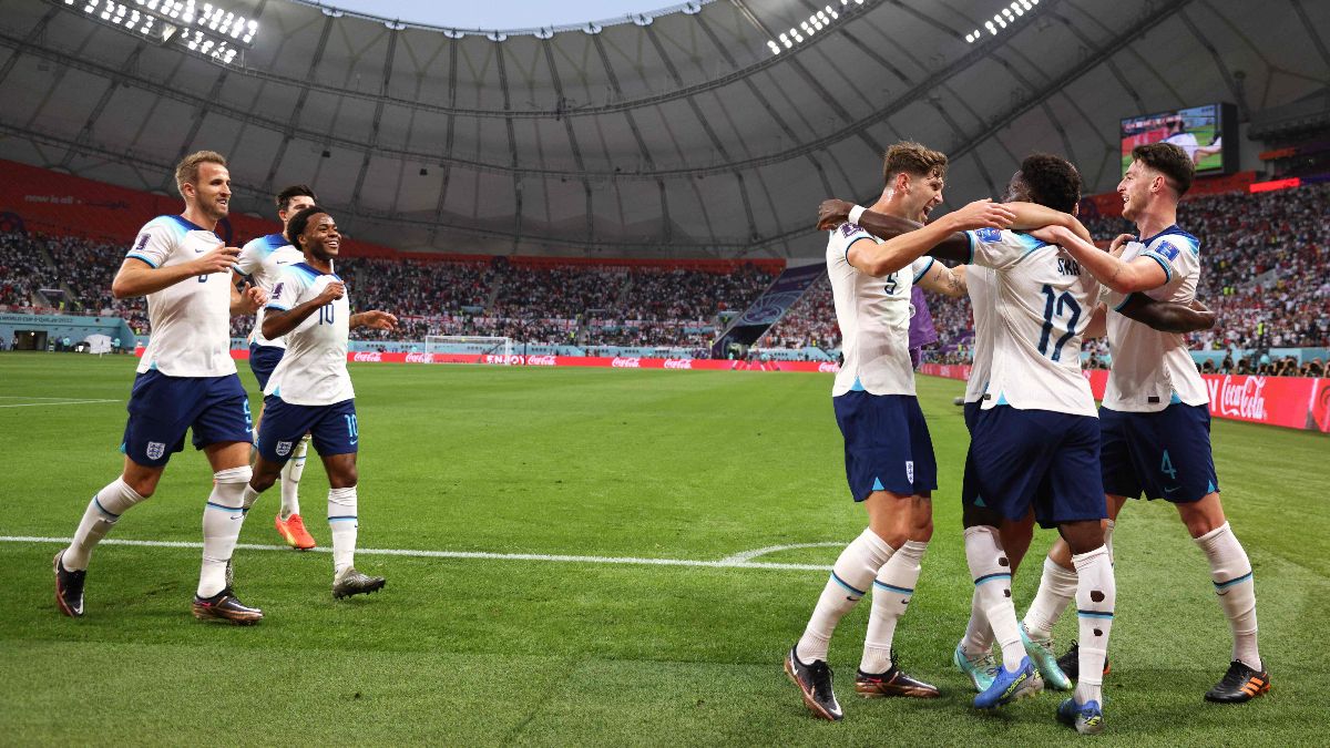 England's forward #17 Bukayo Saka (2R) celebrates with teammates after scoring his team's second goal during the Qatar 2022 World Cup Group B football match between England and Iran at the Khalifa International Stadium in Doha on November 21, 2022.