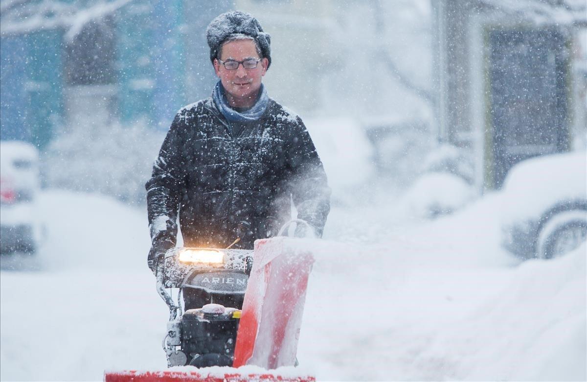 Un hombre retira la nieve durante una tormenta de invierno en Buffalo, Nueva York.