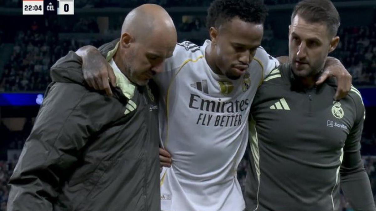 Militao se retira del terreno de juego ayudado por dos miembros del staff técnico del Real Madrid