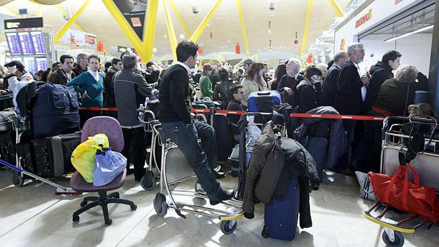 Miles de pasajeros hacen cola a la espera de que se reanude el tráfico aéreo en Barajas.