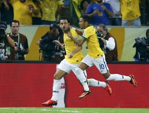 Brazil's Fred celebrates with teammate Neymar after scoring a goal against Spain during their Confederations Cup final soccer match at the Estadio Maracana in Rio de Janeiro