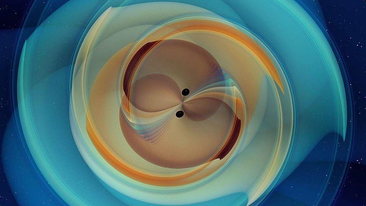 Simulación numérica de dos agujeros negros que se inspiran y se fusionan emitiendo ondas gravitacionalesa.