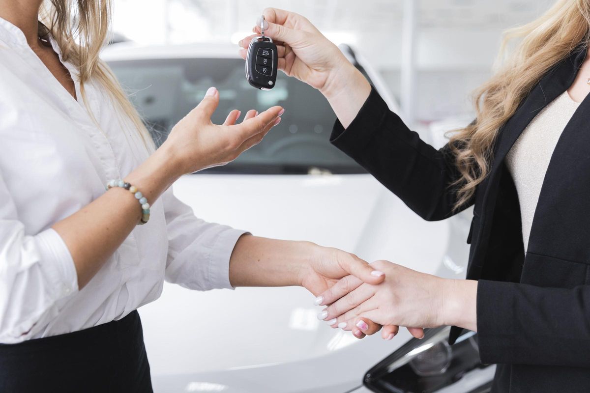 Mujer recibiendo las llaves de su coche