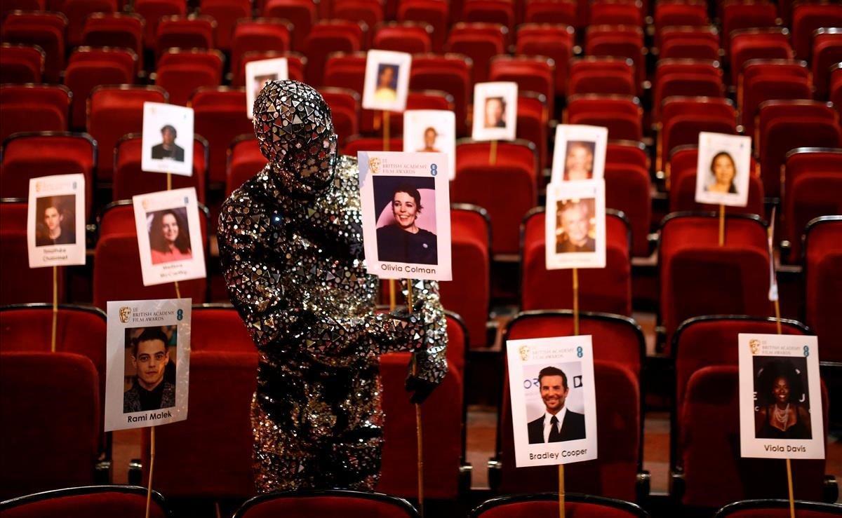 Un miembro del elenco del Cirque du Soleil muestra un lugar para un invitado durante los preparativos para la ceremonia de los Premios de la Academia Británica de Cine y Televisión, en la Royal Opera House de Londres, Reino Unido.