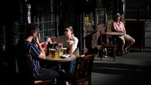 zentauroepp54991720 people enjoy the late afternoon sunshine as they sit outside200918190253