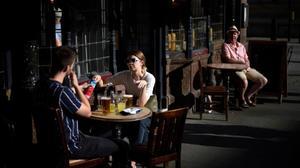 zentauroepp54991720 people enjoy the late afternoon sunshine as they sit outside200918190253