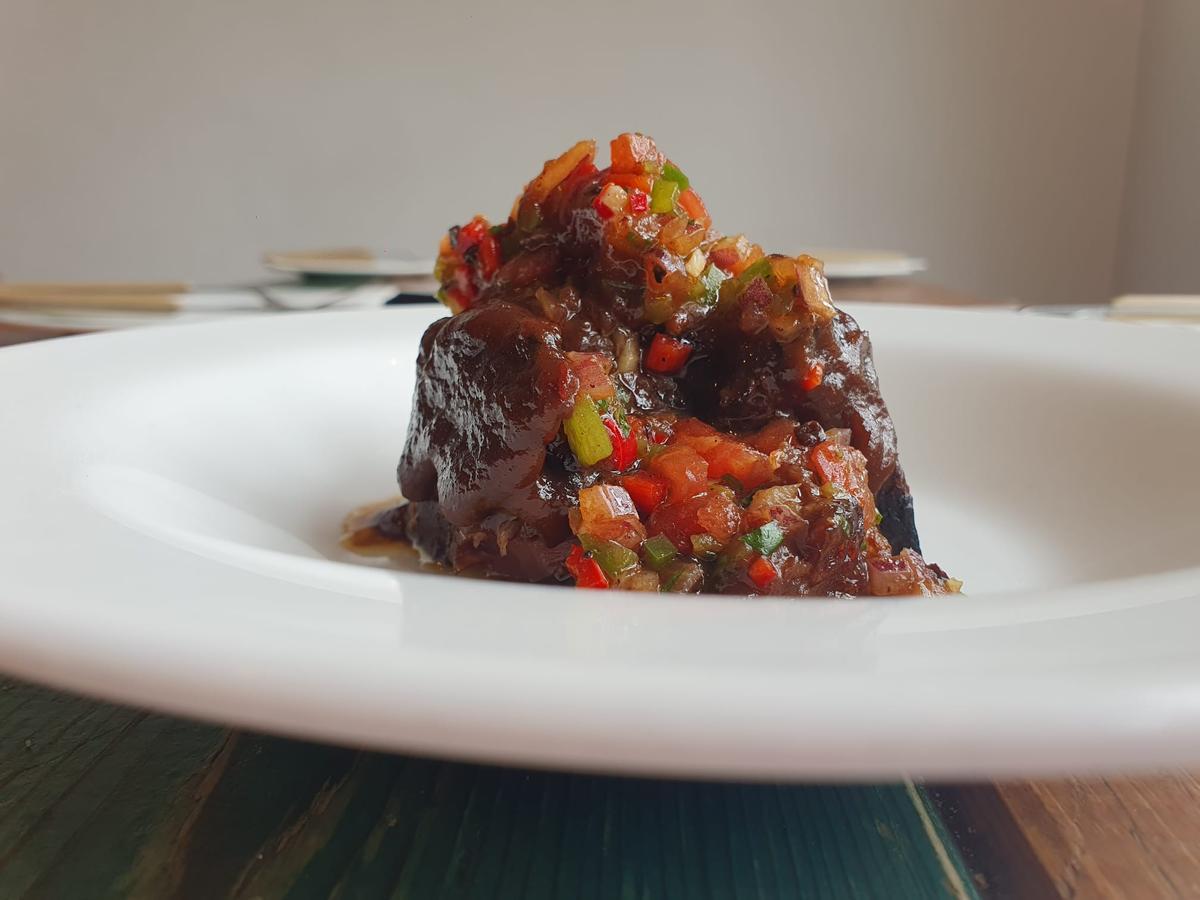 Jarrete de buey asado a baja temperatura y pebre andaluz (salsa chilena parecida al chimichurri ) de Quillo Cocina Flamenca.