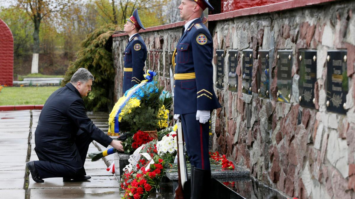 Ukrainian President Poroshenko lays flowers during a commemoration ceremony at a monument to &quot;liquidators&quot; near the Chernobyl nuclear power plant