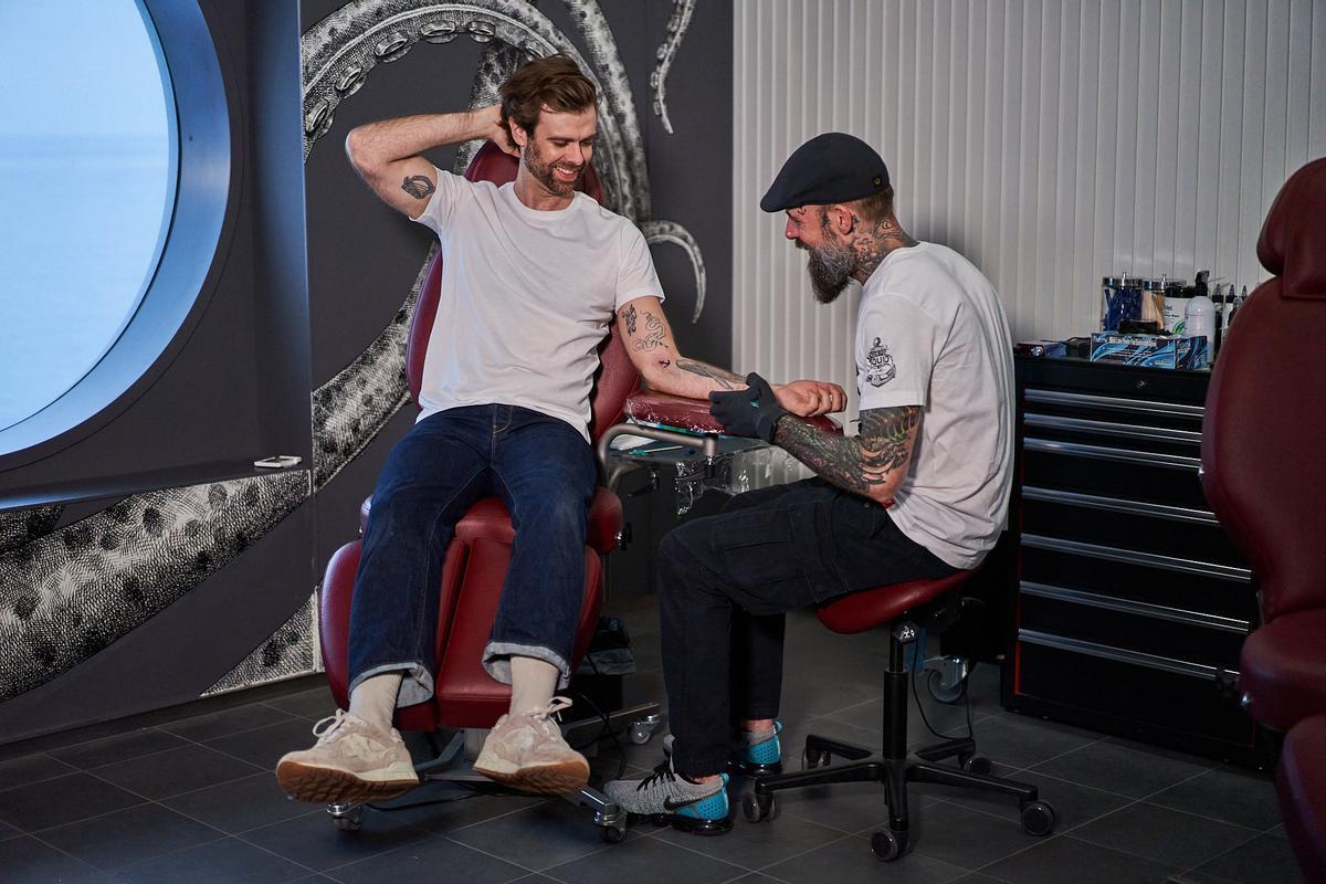 A man gets a tattoo at Squid Ink.