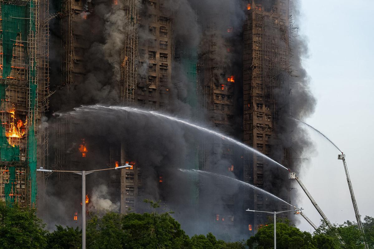 First responders work the scene of a fire at Wang Fuk Court, a residential estate in the Tai Po district of Hong Kongs New Territories on Wednesday, Nov. 26 2025. (AP Photo/Chan Long Hei)