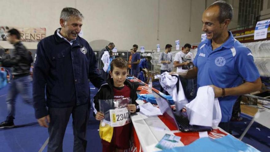 Un joven participante recoge el dorsal y el chip para participar en la San Martiño. // Jesús Regal