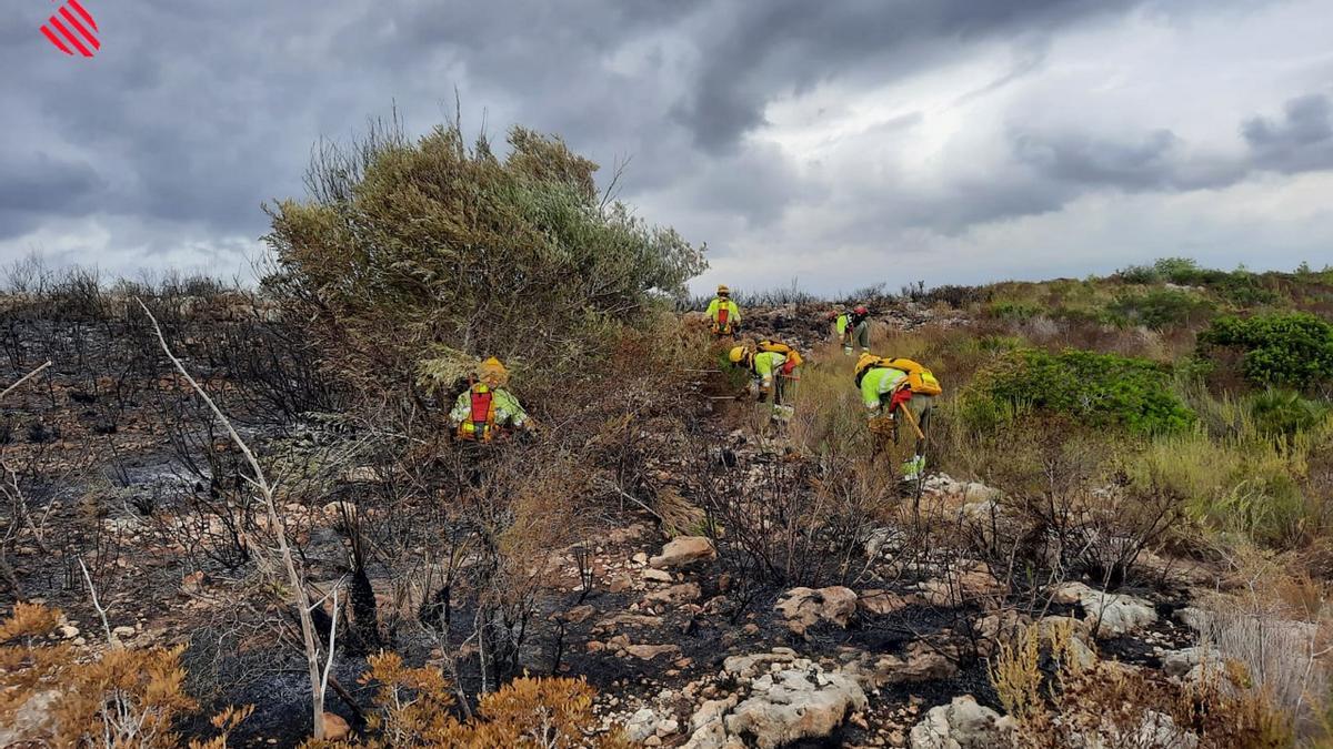 Bomberos trabajando en las tareas de extinción del incendio que ha permanecido activo desde ayer por la tarde en el municipio valenciano.