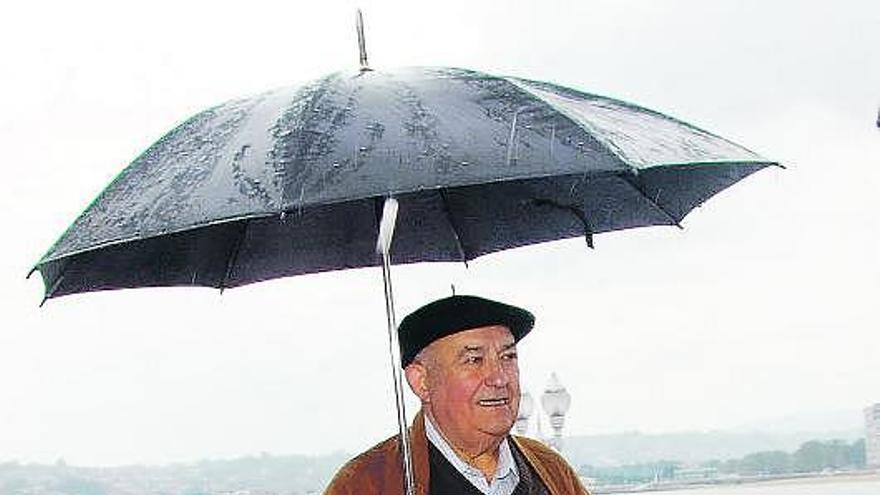 El sacerdote Alberto Torga Llamedo, en el Campo Valdés de Gijón, con Somió al fondo.