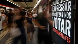 zentauroepp48796238 people walk past an add by the catalan language association 190718210751