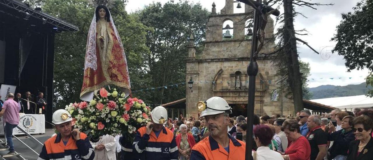 Antiguos integrantes de la Brigada de Salvamento Minero portan la imagen de la Virgen de El Carbayu en las fiestas de 2019. | J. V.