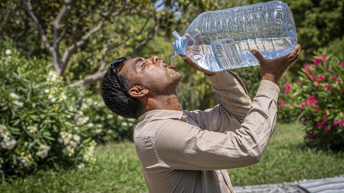 Un vecino de Barcelona bebe agua durante una ola de calor el pasado julio.