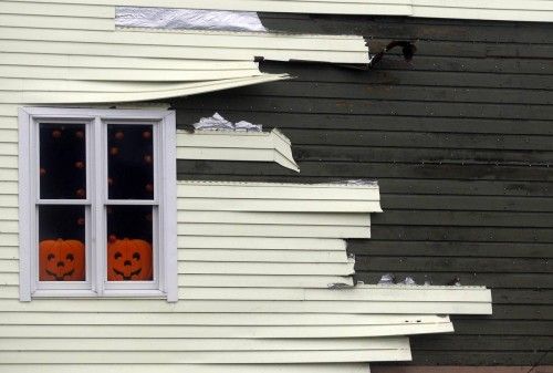 Siding blows off of a house along the coast due to high winds from Hurricane Sandy in Scituate