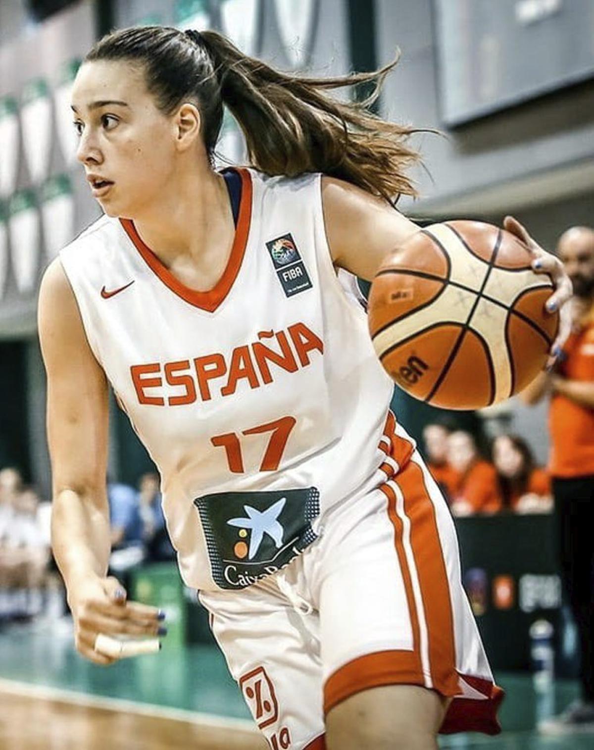 Marta Suárez lanza a canasta con la oposición de una rival.