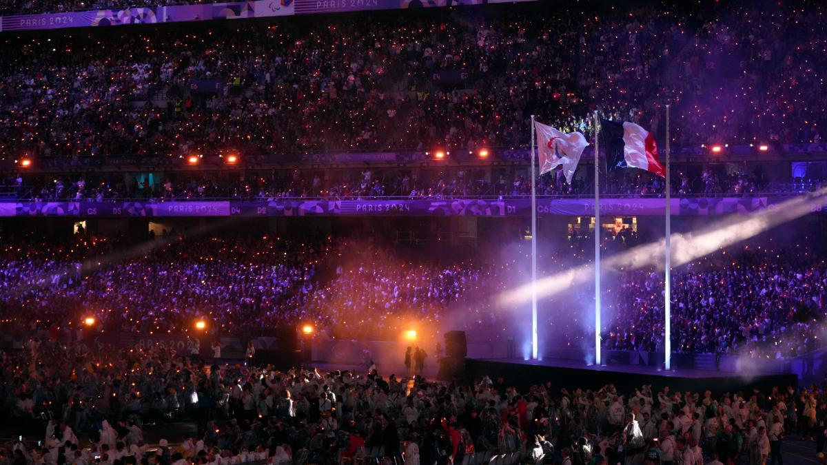 The Paralympic flag flutters next to the French flag during the closing ceremony of the 2024 Paralympics,