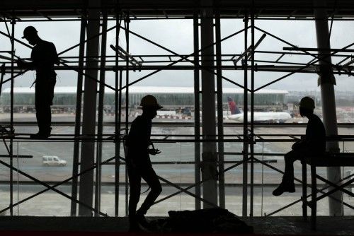 Workers are pictured during renovation and expansion works at Juscelino Kubitschek International Airport in Brasilia