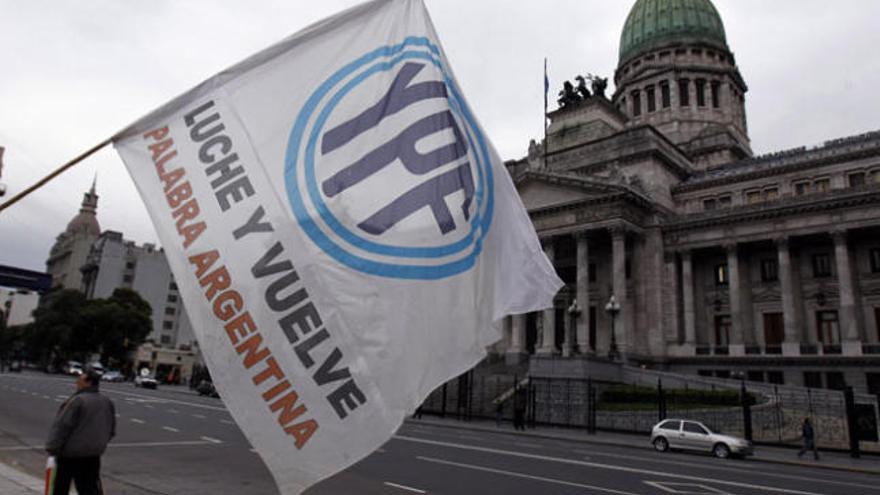 Una bandera con el logo YPF ondea frente al Congreso argentino.